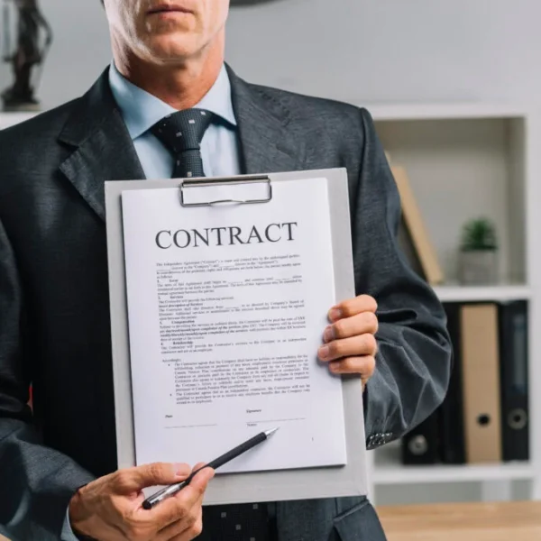 Close up lawyer showing legal contract agreement with pen 1024x683 1 600x600